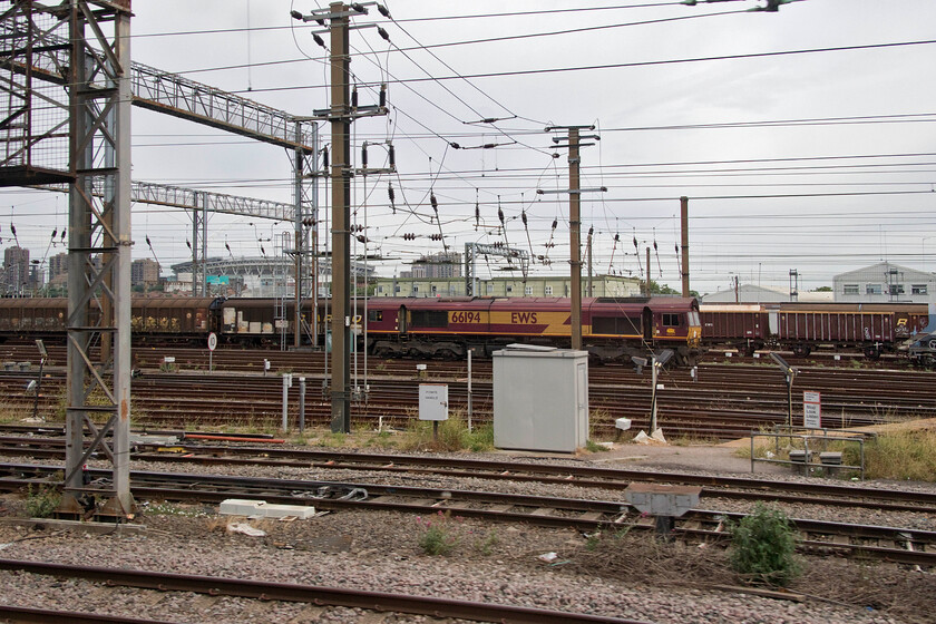 66194, stabled, Wembley Yard 
 Following the last few days characterised by hot and sunny weather the day of our journey home was cloudy and a lot cooler. On passing Wembley Yard 66194 is seen stabled between duties with bot cab doors wide open. With no air conditioning crews complain regularly about conditions inside the driving compartment of the Class 66s with hot weather making them unpleasant places to work. 
 Keywords: 66194 Wembley Yard