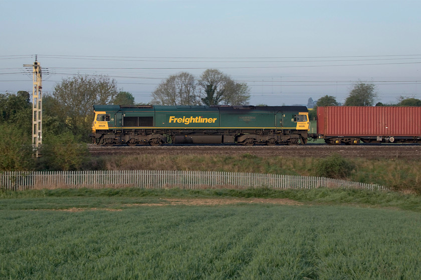 66526, 03.39 Garston-London Gateway (4L52, 26E), between Roade & Ashton 
 A 'mild' pan photograph of 66526 'Driver Steve Dunn (George)' leading the early morning 4L52 03.39 Garston to London Gateway Freightliner on the up fast line. The image is taken between the villages of Ashton and Roade on a chilly morning with a very heavy dew that soaked through my footwear as I was not adequately prepared for it! As can be seen from the sky and the lighting, there is a little morning haze which has just taken the edge off the sunlight. 
 Keywords: 66526 03.39 Garston-London Gateway 4L52 between Roade & Ashton Driver Steve Dunn (George) Freightliner