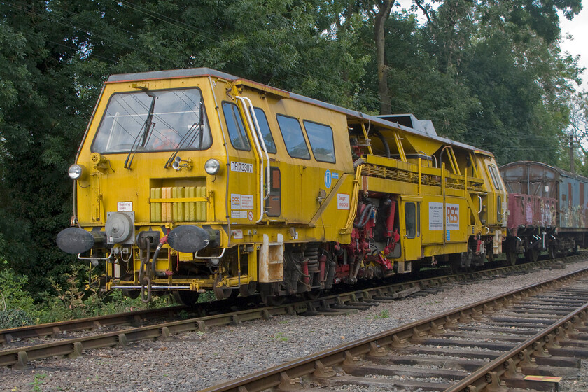 DR73307, stabled, Pitsford sidings 
 The acquisition or hiring of various redundant track machinery is an important aspect of the many heritage lines around the country. It helps with the maintenance of their tracks and when extensions or remodelling is being undertaken. DR73307 is a Plasser & Theurer 07-275 T tamper that has recently arrived on the line presumably in association with their work extending the line south towards their new station at Boughton, see.... https://www.nlr.org.uk/boughton-extension/ 
 Keywords: DR73307 Pitsford sidings