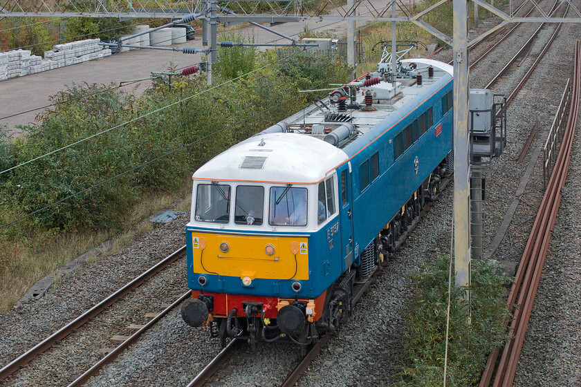 1. 86259, 12.07 London Euston-Rugby CS (0Z89, 35E), site of Roade station 
 86259 'Les Ross/Peter Pan' passes light engine through Roade. I have not quite managed to frame the 0Z89 12.07 Euston to Rugby CS incorrectly thinking that it would fit between the bridge I'm standing on and the electrification mast! The previous day the veteran AL6 worked The Cumbrian Coast Express charter that I managed a pretty poor photograph of as it passed Milton crossing, see....https://www.ontheupfast.com/p/21936chg/30060904906/x86259-cumbrian-coast-express-06 
 Keywords: 86259 12.07 London Euston-Rugby CS 0Z89 site of Roade station Les Ross Peter Pan