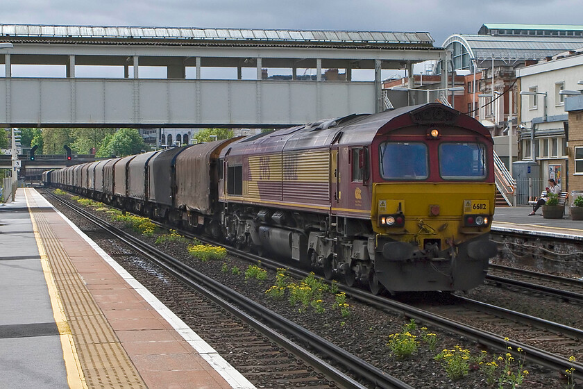 66112, 08.12 Dollands Moor-Margam (6V13), Kensington Olympia station 
 This is a train that I have never photographed so I was pleased when it appeared within a few minutes of the passage of the charter seen previously. It is a tricky train to photograph as Monday to Friday it passes through London in the depths of the night with it only running in daylight on a Saturday morning. 66112 leads a rake of empty IHA bogie-covered steel coil carrier wagons as the 6V13 08.12 Dollands Moor to Margam. In the other direction, it takes South Wales-produced steel to the continent for the Broekman Group in Rotterdam or Myriad in Maubeuge France via Calais Frthun running on alternate days. 
 Keywords: 66112 08.12 Dollands Moor-Margam 6V13 Kensington Olympia station