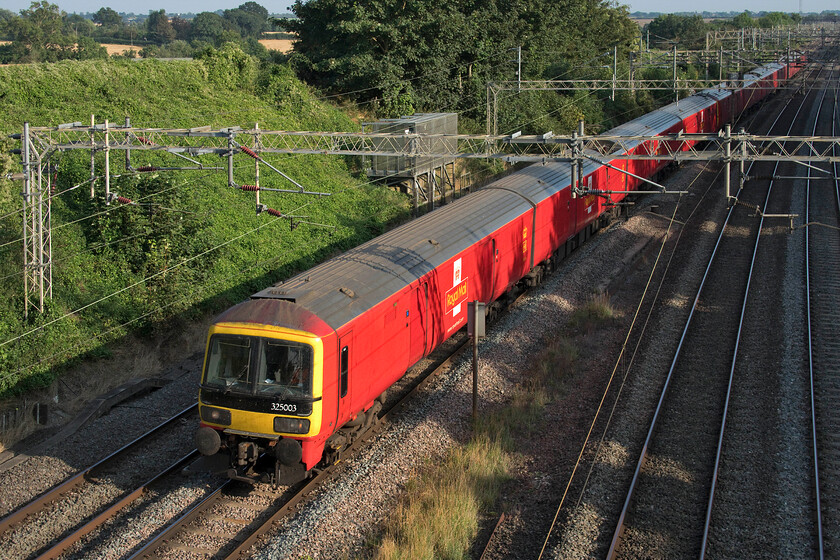 325003, 325012 & 325009, 16.21 Willesden PRDC-Shieldmuir (1S96, RT), Victoria bridge 
 Dating from 1995/196 the ABB (Derby) built units have been in continuous service ever since still operating a number of daily trains up and down the WCML by DB Cargo. 325003, 325012 and 325009 operate the 1S96 16.21 Willesden to Sheildmuir Royal Mail train this time routed on the down slow that will take the train through Northampton. On another day it may be routed on the fast line depending on its timings and what other traffic is doing in the area. 
 Keywords: 325003 325012 325009 16.21 Willesden PRDC-Shieldmuir 1S96 Victoria bridge Royal Mail