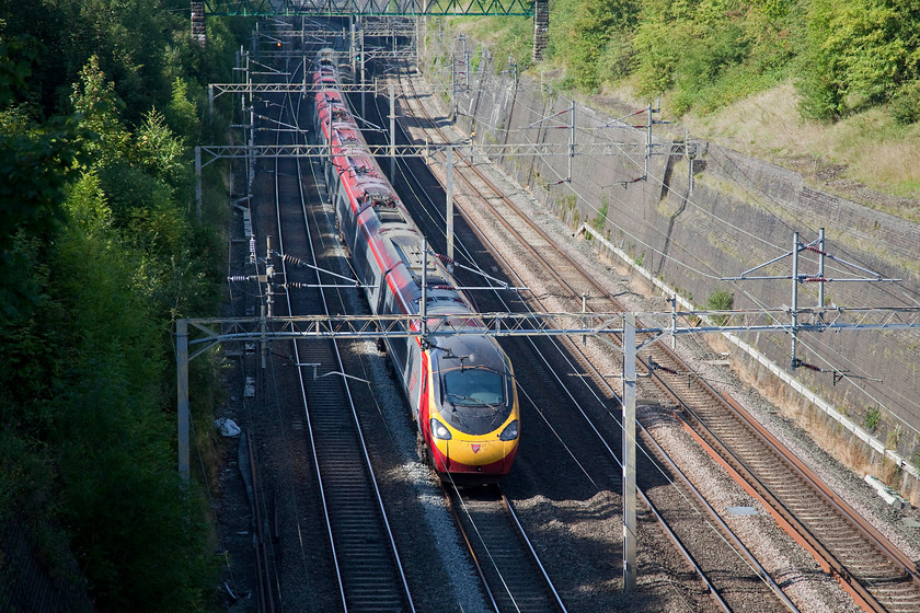 390117, VT 11.40 Glasgow Central-London Euston (1M12, 2L), Roade Cutting 
 390117 'Virgin Prince' takes the up fast through Roade Cutting forming the 11.40 Glasgow Central to London Euston. This 1M12 service covered the 401 miles arriving just two minutes late. 
 Keywords: 390117 1M12 Roade Cutting