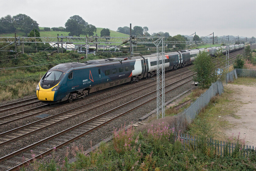 390112, VT 11.10 London Euston-Glasgow Central (1S58, 1E), Stableford bridge 
 390112 heads north past Stableford working the 11.10 London Euston to Glasgow Central. It has started raining by this time adding further misery to an incredibly dull and grey day! 
 Keywords: 390112 11.10 London Euston-Glasgow Central 1S58 Stableford bridge Avanti West Coast Pendolino