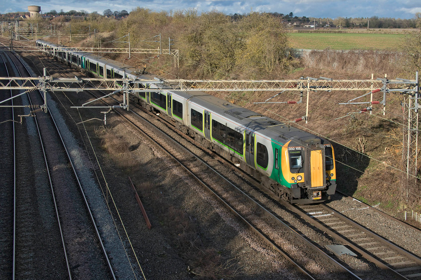 350105 & 350258, LN 10.51 Crewe-London Euston (1Y56, 1L), Victoria bridge 
 In a burst of winter sunshine 350105 and 350258 pass Victoria bridge just south of Roade in Northamptonshire working the 10.51 Crewe to Euston. 
 Keywords: 350105 350258 10.51 Crewe-London Euston 1Y56 Victoria bridge London North Western Desiro