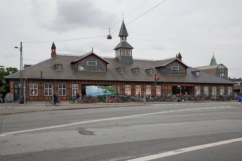 Frontage, sterport station 
 The rather grand frontage of sterport station is seen from street level. It was opened in 1897 and today handles thirty thousand passengers daily. It takes its name from the historic sterport city gate that is close by. After falling into a state of poor repair DSB restored the station in the early 2000s with the station platforms radically modernised. 
 Keywords: Frontage sterport station