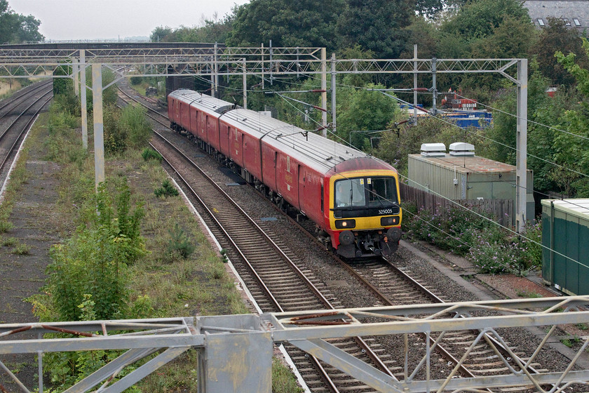 325005, 11.20 Crewe TMD-Wembley PRDC (5A91, 9E), site of Castlethorpe station 
 A daily working is the 5A91 empty running of one of Royal Mail's Class 325s from Crewe to Wembley's Park Royal depot. Often it is a pair of units but on this day just 325005 is working the 11.20 from Crewe. The unit is seen heading south past the site of Castlethorpe's station that closed in September 1964 after a prolonged campaign to keep it open led, at one stage, by the business tycoon and Labour MP for Buckingham and pension thief Robert Maxwell no less! 
 Keywords: 325005 11.20 Crewe TMD-Wembley PRDC 5A91 site of Castlethorpe station Royal Mail