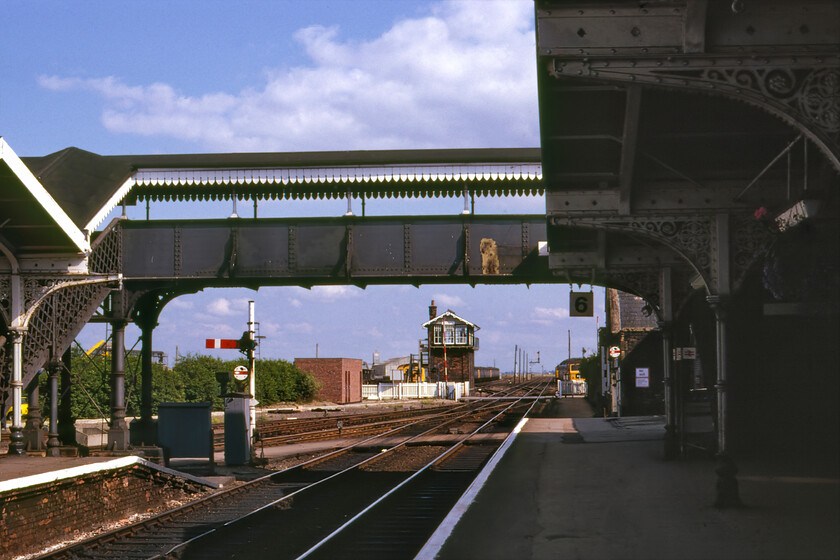 March station 
 The scene looking southeast through March station has actually changed little today from this 1981 view. The semaphores, the signal box, the level crossing and footbridge are still extant but the stabled class 47s and stored Class 308 EMUs are long gone! Today, just two platforms are in use but there are plans to reopen the presently mothballed platforms to the left of where I am standing here with the possible reinstatement of the Wisbech branch. However, discussions of this have been going on for years with no real progress apart from the odd feasibility study or other! 
 Keywords: March station