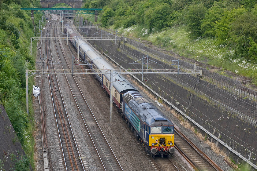 57309, 13.09 London Euston-Crewe down ecs (5Z58), Roade cutting 
 In a change from the outward ecs working seen three days earlier, 57309 is seen on the rear of the returning Three Peaks Challenge charity event ecs move. The 13.09 Euston to Crewe 5Z58 working is seen passing through Roade cutting heading for the stock's base and much in need of a good clean I expect! 
 Keywords: 57309 13.09 London Euston-Crewe down ecs 5Z58 Roade cutting DRS Direct Rail Services