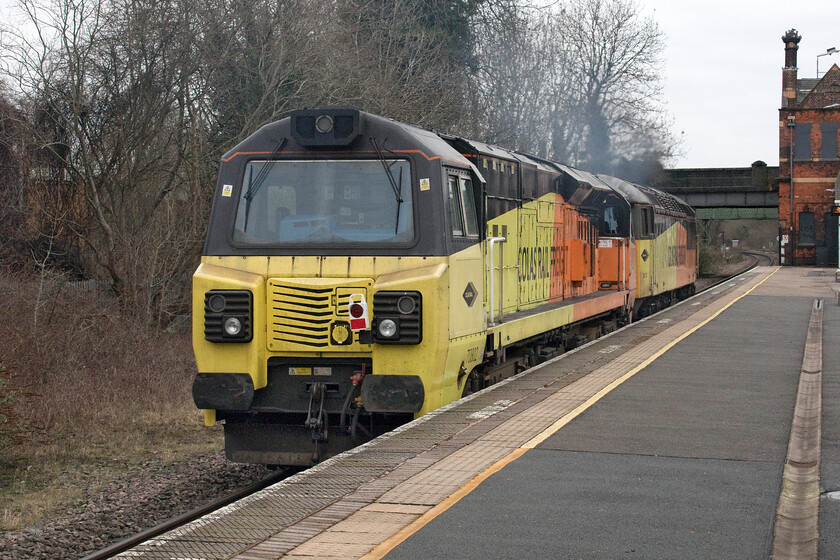 70802 & 56113, 08.30 Bescot Yard-Doncaster Works Wabtec (0Z75, 3E), Water Orton station 
 Having had various derogatory names applied to them due in a large part to their controversial and, to some, ugly design the Class 70s have been operating on the network for over ten years now. I do not know why Colas' 70802 was being towed from Bescot to Doncaster Works by 56113 but the pair are seen passing through Water Orton station as the 0Z75. 
 Keywords: 70802 56113 08.30 Bescot Yard-Doncaster Works Wabtec 0Z75 Water Orton station Grid Ugly Betty Ugly Duckling