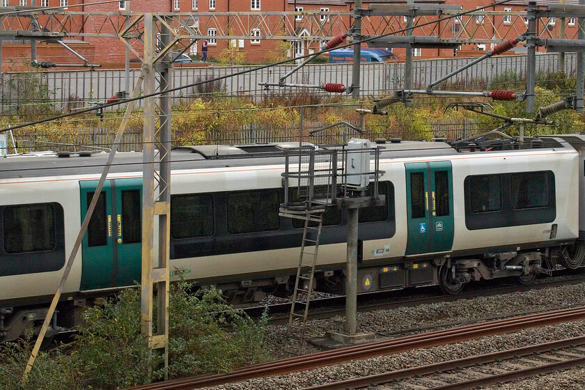 67544 (350244), 10.05 Wolverton Centre Sidings-Ardwick TMD (5Z77, 1E), site of Roade station 
 I don't normally take badly cropped pictures of coaches passing at speed! However, this photograph shows coach 67544 of set 350244 revealing the darker black patch on its flanks where the London Northwestern logo and graphics have been removed. This is the first Desiro heading off to pastures new as the 5Z77 10.05 Wolverton Centre Sidings to Ardwick TMD where it will enter service with Northern. Over the next few weeks and months, all the Class 350/2s will come off-lease and head off up north! 
 Keywords: 67544 350244 10.05 Wolverton Centre Sidings-Ardwick TMD 5Z77 site of Roade station London Northwestern Desiro