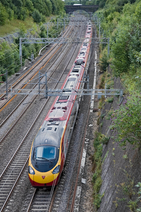 Class 390, VT 12.05 London Euston-Liverpool Lime Street, Roade cutting 
 An unidentified Class 390 Pendolino works the 12.05 Euston to Liverpool Virgin service through Roade cutting. A quick check of the rain reveals that it is one of the eleven-car reconfigured sets. 
 Keywords: Class 390 12.05 London Euston-Liverpool Lime Street Roade cutting Virgin Pendolino