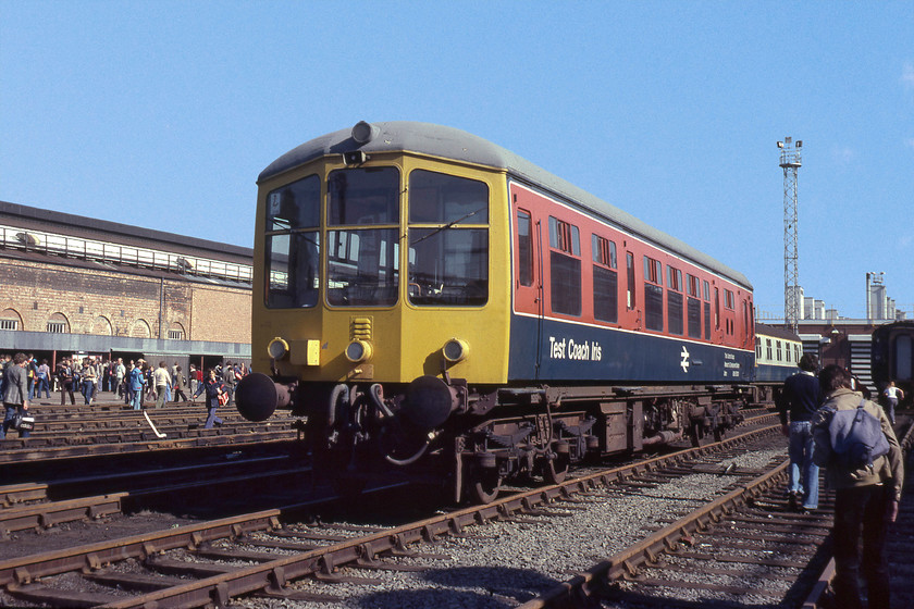 RDB975010, on display, Crewe Works 
 A number of very similar images to this can be sourced on the internet as the former Derby Lightweight DMU had been put in this strategically advantageous position in the open at Crewe Works open day. This unit was constructed in 1956 as 79900, originally as part of a two-car set. It was withdrawn from passenger service in 1967, becoming a departmental route learner as RDB975010. It later was named 'Iris' and became a test coach. As well as running all over the network fulfilling this function, it was a regular attendee at open days and the like. It was withdrawn in 1999 and entered preservation. It is still in service today on the Ecclesbourne Railway having been beautifully restored and running once again as 79900. It holds the accolade as being the oldest first generation DMU in existence. 
 Keywords: RDB975010 on display Crewe Works