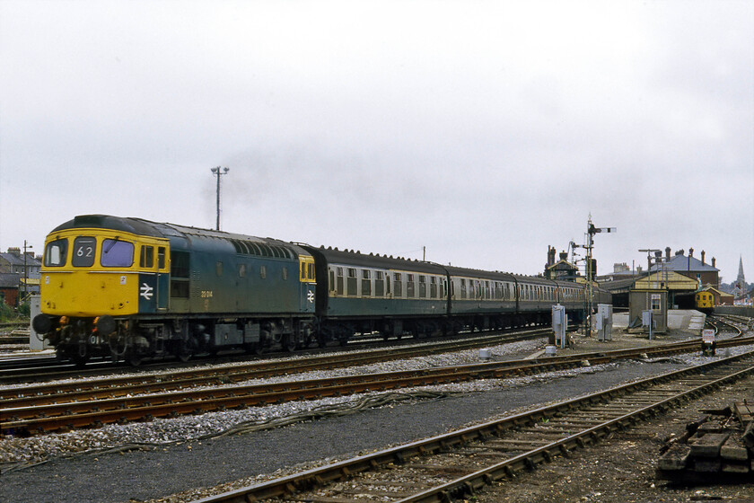 33014, 14.10 London Waterloo-Salisbury (1L87), Salisbury West Yard 
 Having terminated at Salisbury station a short time earlier the 14.10 from London Waterloo leaves the station led by 33014. The train would run the short distance to the West Yard as empty stock to then reverse back into the station where the Crompton would run round and lead the train back to London a little later. Notice the evidence of considerable track rationalisation associated with the resignalling of the area that would be going live some nine days after this photograph was taken. 
 Keywords: 33014 14.10 London Waterloo-Salisbury 1L87 Salisbury West Yard Crompton