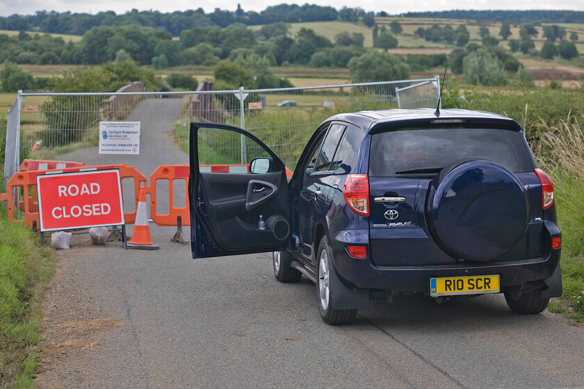 R10 SCR, closed The Slips & Harrowden Junction bridge, in connection with MML electrification 
 The closure of The Slips, a road that links the A509 at Great Harrowden with the village of Finedon will cause considerable inconvenience as it is a popular local cut through. It is also going to impact on railway photographers as the vantage point afforded by the bridge, seen in the background, is a classic one and will be much missed. It is unlikely that the new bridge that will eventually replace it will allow quite such a range of angles and positions. 
 Keywords: R10 SCR closed The Slips & Harrowden Junction bridge in connection with MML electrification