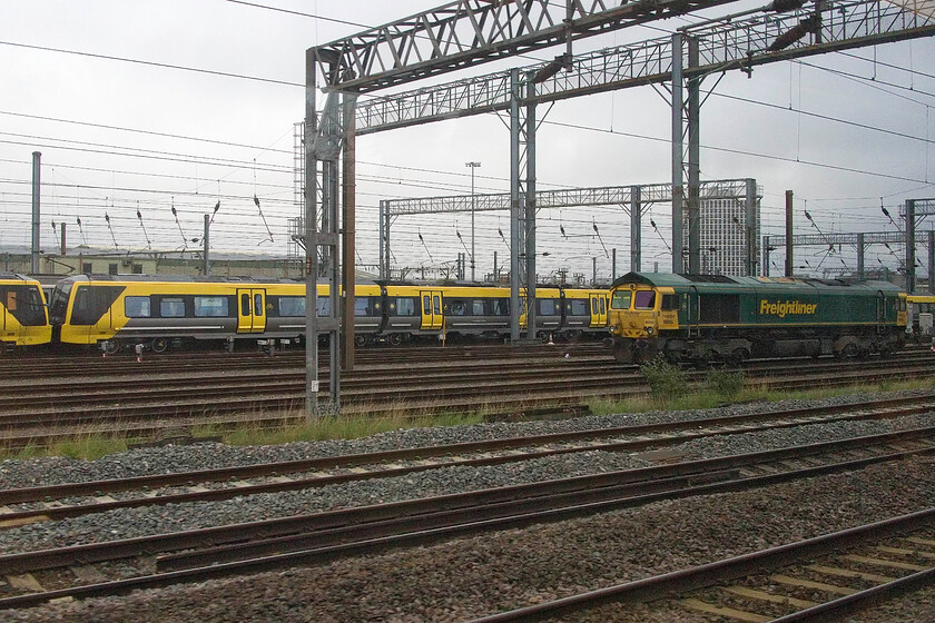 Class 777s & 66952, stabled, Wembley Yard 
 The old and new stand side by side in Wembley Yard. A pair of brand-new Merseyrail Class 777s are lined up with a warm-stored Great Eastern Class 321 just visible behind. The Class 321s have been in this spot for a number of months now facing an uncertain future that will probably involve a final trip to South Wales for scrapping. 66592 stabled to the right is not one of my most photographed members of the class with just one other image captured to this date. 
 Keywords: Class 777 66952 Wembley Yard