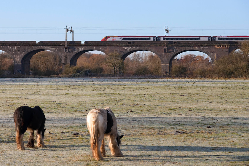 Class 390, VT 07.35 Manchester Piccadilly-London Euston (1A10, RT), Haversham SP818425 
 An unidentified class 390 heads south forming the 07.35 Manchester to Euston service. The two horses do not even give it a glance as it crosses Haversham Viaduct just north of Wolverton station. Historic England state that the viaduct 'was one of the principal landmarks of the first trunk railway and one of the earliest viaducts on this scale.' 
 Keywords: Class 390 07.35 Manchester Piccadilly-London Euston 1A10 Haversham SP818425