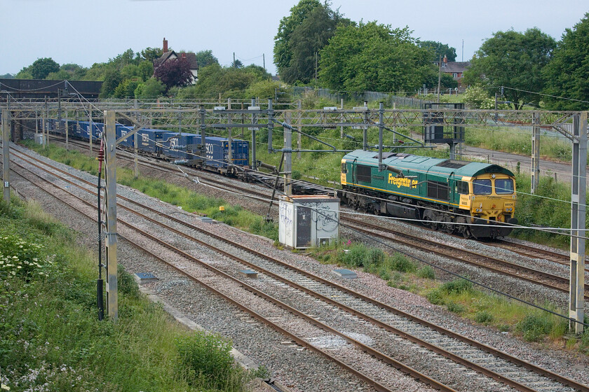 66506, 12.41 DIRFT-Tilbury (4L48, 178L), site of Roade station 
 Not the greatest composition is shown in this photograph but I was totally caught out by the passing of the 4L48 Tesco Express that was running nearly four hours late! The cause of the extensive delay could be a failure of one of DRS' locomotives that usually haul this service with them having to muster a replacement form somewhere or another. 66506 'Crewe Regeneration' hauls the beleaguered 12.41 DIRFT to Tilbury that eventually arrived some one hundred and seventy-eight minutes late past the site of Roade's former station. 
 Keywords: 66506 12.41 DIRFT-Tilbury 4L48 site of Roade station Freightliner Crewe Regeneration