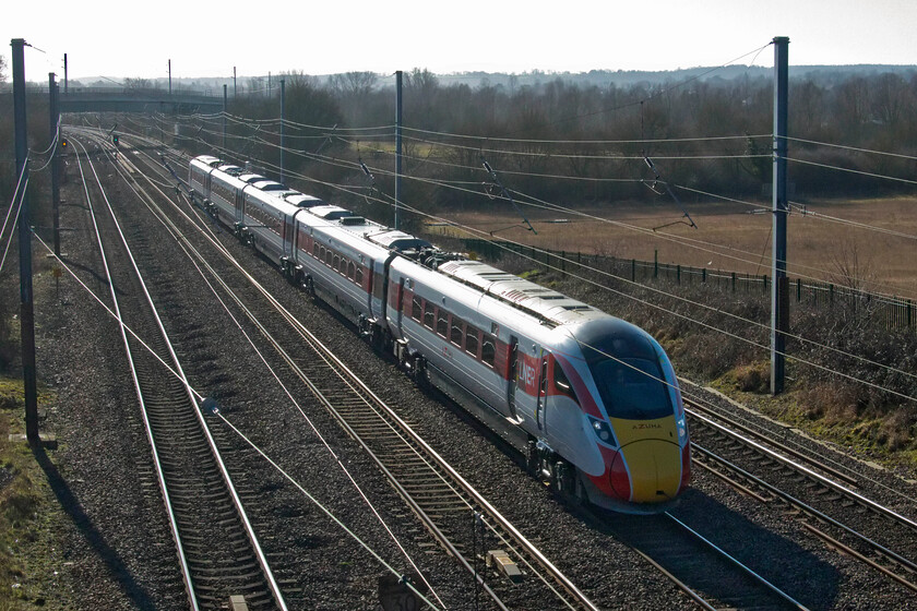 800210, GR 11.33 London King's Cross-Harrogate (1D12, 1E), Ickleford TL188317 
 Breaking the photographic rules is a hobby of mine; this includes taking photographs into the sun! On a glorious, if chilly morning 800210 speeds northwards with the 11.33 King's Cross to Harrogate service. The train is seen from a footbridge that spans the ECML near the village of Ickleford just north of Hitchin. 
 Keywords: 800210 11.33 London King's Cross-Harrogate 1D12 Ickleford TL188317 LNER Azuma.jpg