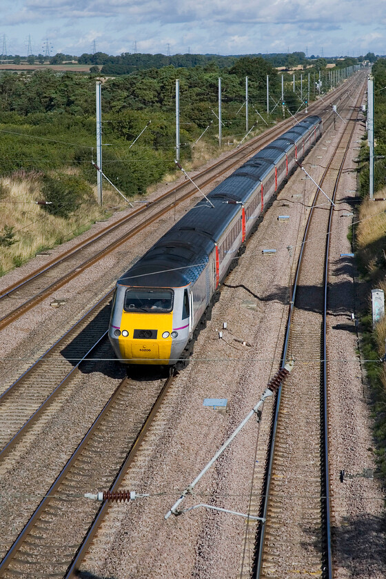 43206 GN 08.40 Leeds-London King's Cross (1A18), Essendine TF042129 
 HST power car 43206 in its East Coast livery leads the 08.40 1A18 Leeds to King's Cross past Essendine. The stock, however, is hired in from East Midlands Trains wearing their house colours but with no branding. Stoke Bank stretches off into the distance climbing for some twelve miles to the summit on largely straight track. 
 Keywords: 43206 08.40 Leeds-London King's Cross 1A18 Essendine TF042129 HST East Coast