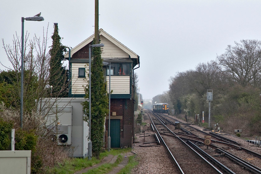 Minster Signal Box (SR, 1929) 
 Minster signal box, as shown here, is the second box built with this name. This one was built by the Southern in 1929 but has many of the architectural features of the Saxby and Farmer original. The semaphores all were wiped away in 1981 when a large amount of rationalisation took place in the area. However, the box still controls the colour lights and the triangular junction. In the distance, a class 375 takes the Dover line via Deal. 
 Keywords: Minster Signal Box (SR, 1929)