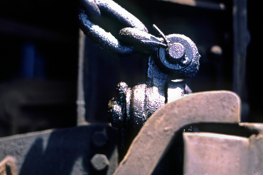 45076, braking shackle, Severn Tunnel Junction 
 As I was undertaking an A-Level in photography at this time I was always on the lookout for a 'different' type of photograph, looking back now at the slides and negatives a lot were a little over-tried to the point of being pretentious! However, I do like the dark black oilyness of this particular image. It shows the brake shackle on the bogie of 45076 whilst it is stabled at Severn Tunnel Junction. 
 Keywords: 45076 braking shackle Severn Tunnel Junction Peak