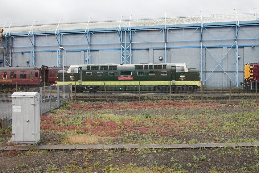 55002 & 09017, stabled, NRM yard 
 As our train passes the National Railway Museum at York, 55002 'The King's Own Yorkshire Light Infantry' is on display at the rear of the min building. 09017 is just poking its nose into the shot on the right. 
 Keywords: 5500 09017 NRM yard