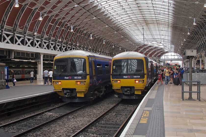 165106, GW 12.07 Oxford-London Paddington & 165104, GW 11.50 Moreton-in-Marsh-London Paddington, London Paddington station 
 Thames Turbo action at Paddington! To the left 165106 has just terminated with the 12.07 limited stop service from Oxford while 165104 has just arrived with the 11.50 from Moreton-in-Marsh and is just disgourging its passengers. 
 Keywords: 165106 12.07 Oxford-London Paddington 165104 11.50 Moreton-in-Marsh-London Paddington London Paddington station FGW First Great Western Thames Turbo.