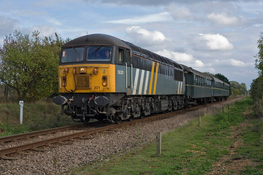 56301, 14.10 Peterborough Nene Valley-Wansford (2M50), Sutton Cross TL103980 
 56301 approaches the journey's end leading the 14.10 Peterborough Nene Valley to Wansford autumn gala service. As a young schoolboy spotter, I remember being very excited when I saw my first Class 56 back in the late 1970s. Little did I think that as a 'late' middle-aged man, firstly I would still be out on the lineside and secondly, witnessing mainline registered Class 56s hauling passenger trains! 
 Keywords: 56301 14.10 Peterborough Nene Valley-Wansford 2M50 Sutton Cross TL103980