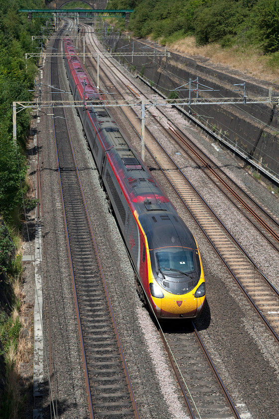 390148, VT 11. 36 Manchester Piccadilly-London Euston (1A20, 4E), Roade Cutting 
 390148 'Flying Scouseman' heads through Roade Cutting working the 11.36 Manchester Piccadilly to London Euston. At this time this was one of the few remaining class 390s still in their as-built livery. 390155 carried the name 'Virgin Harrier' but lost his name following the Liverpool Echo newspaper's Train naming competition in June 2017. 
 Keywords: 390148 1A20 Roade Cutting