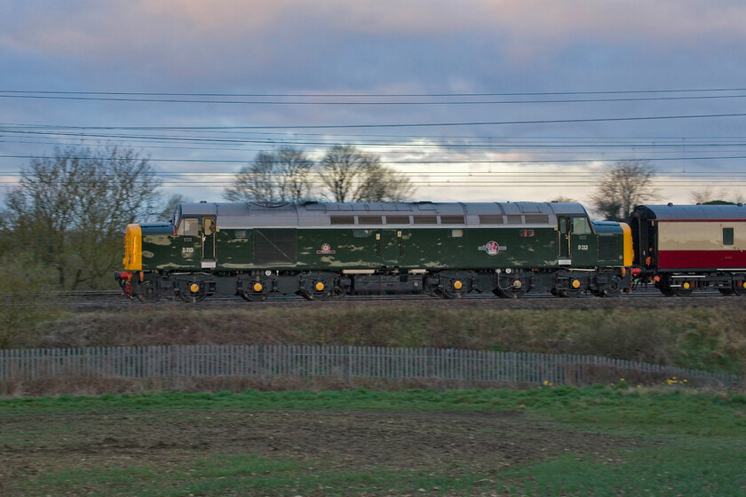 D213, outward leg of The Cotswold Explorer, 06.30 Northampton-Worcester Shrub Hill (1Z46, 40L), between Roade & Ashton 
 There had been some speculation as to what would be hauling Saphos' The Cotswold Explorer charter with LSL providing the stock and motive power. As it was such a still and quiet morning I was able to hear the locomotive some distance from where I was standing between Roade and Ashton in Northamptonshire and the familiar sound of an English Electric 16SVT confirmed it was a Class 40! 40013 'Andania' looks superb in the half-light of this chilly March morning leading the train that had just started out from Northampton at 06.30 heading for Worcester Shrub Hill with steam taking over in West London. 
 Keywords: D213 The Cotswold Explorer, 06.30 Northampton-Worcester ShShrub Hill 1Z46 between Roade & Ashton Andania Whistler