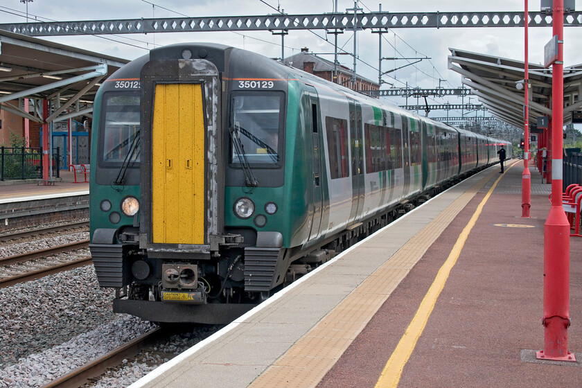 350129, LN 12.55 Northampton-Birmingham New Street (2T85, 1L), Rugby station 
 The second and very delayed part of our journey from Northampton to Liverpool arrives at Rugby station. We boarded this train in order to get to Birmingham New Street instead of our planned journey via the Trent Valley route. 350129 and an unidentified 350/4 are working the 12.55 Northampton to Birmingham service. 
 Keywords: 350129 12.55 Northampton-Birmingham New Street 2T85 Rugby station London Northwestern Desiro