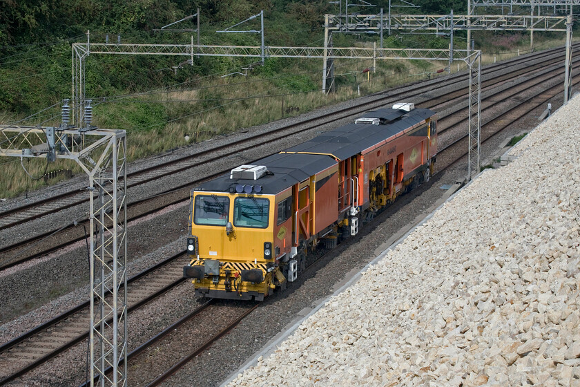 DR73947, 10.00 Rugby Depot Access Line-Neasden South Sidings (8E), Ashton Road bridge 
 Unfortunately, just missing out on the sun on its flanks, Colas operated Plasser & Theurer 08-4x4/4S-RT Switch & Crossing Tamper number DR73947 passes on the up slow line just south of Roade in Northamptonshire. It was running as the 10.00 Rugby Depot Access Line to Neasden South Sidings that I could not ascertain the headcode for! 
 Keywords: DR73947 10.00 Rugby Depot Access Line-Neasden South Sidings Ashton Road bridge Plasser & Theurer 08-4x4/4S-RT Switch & Crossing Tamper