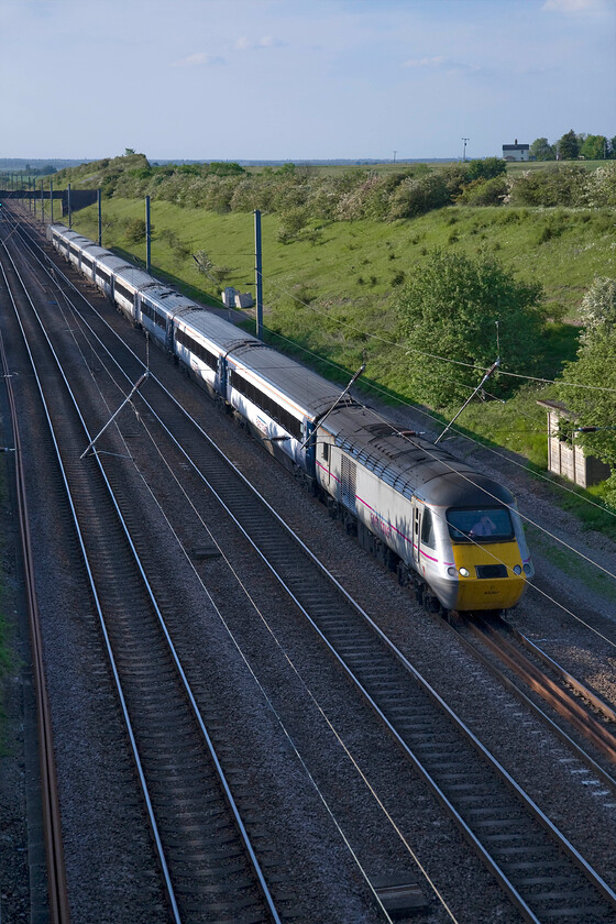 43307, GR 14.00 Craigentinny-London King's Cross ECS (5N33), New England bridge TL219796 
 I am sure that East Coast has its reasons that I am not party to but, quite why is an HST runs empty all the way from Scotland to London is a mystery? Power car 43307 left Craigentinny depot at 14.00 running as 5N33 to King's Cross. 43307 has been on the ECML all of its working life being introduced in December 1978 as part of set 254026. In the very distance to the left above the aqueduct is the tower of the redundant Anglican church of St Andrews Church that stands in an isolated position in fields adjacent to the ECML and is clearly visible from passing trains, see.... http://www.woodwalton.org.uk/ 
 Keywords: 43307 14.00 Craigentinny-London King's Cross ECS 5N33 Wood Wennington TL219796 East Coast HST New England bridge