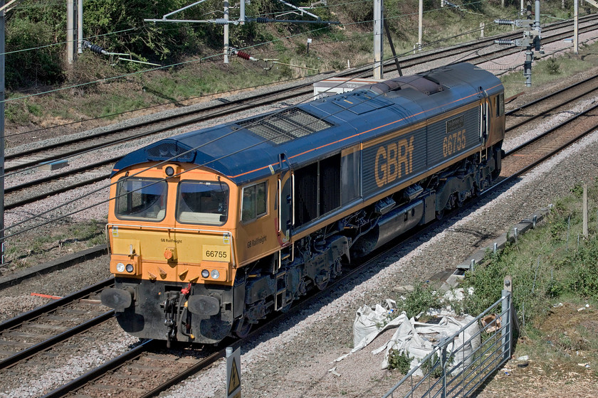 66755, 09.56 Bescot-London Euston via Bedford St. John`s & St. Albans Abbey (0L66, 90E), site of Roade station 
 Named after the freight champion and former chairman of the Rail Freight Group (RFG) 66755 'Tony Berkeley OBE RFG Chairman 1997-2018' passes light engine past the site of Roade station. It was running as the 09.56 Bescot to Euston route learner that was making this trip via a run down the presently closed Marston Vale line to Bedford St. Johns and then a quick dash up the branch to St. Albans Abbey. Quite why a route learner was permitted to operate in these two-metre distancing times I am not sure? The locomotive ran as planned to Bedford but missed out the St. Albans Abbey leg arriving a hefty ninety minutes early at Euston. 
 Keywords: 66755 09.56 Bescot-London Euston via Bedford St. Johns St. Albans Abbey 0L66 site of Roade station route learner Tony Berkeley OBE RFG Chairman 1997-2018