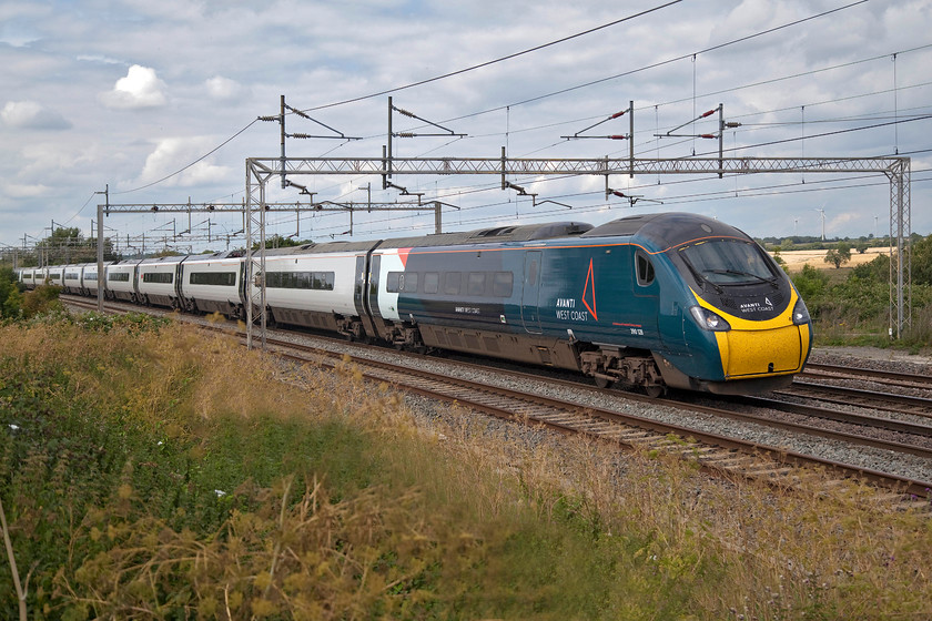 2. 390128, VT 13.55 Manchester Piccadilly-London Euston (1A41, RT), Gordon's Lodge 
 Having been so used to the Pendolinos being in Virgin red from their introduction some eighteen years ago, seeing them in the Avanti livery has taken a little getting used to. However, I am warming to their paint scheme and I am pleased that the vast majority of the bodysides are remaining in the transitional white. 390128 passes Gordon's Lodge just north of Hanslope Junction with the 13.55 Manchester Piccadilly to Euston service. 
 Keywords: 390128 13.55 Manchester Piccadilly-London Euston 1A41 Gordon's Lodge Avanti West Coast