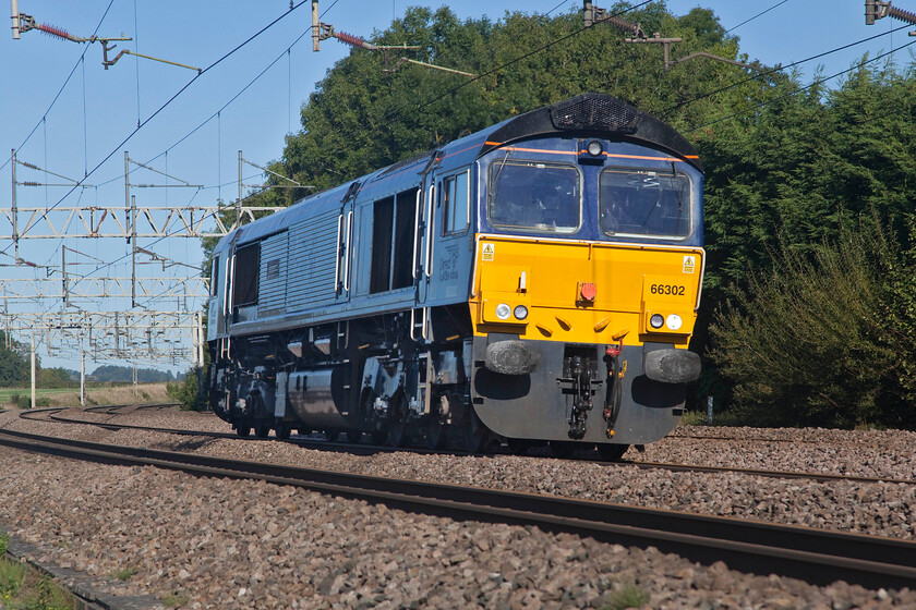 66302, 09.14 Gresty Bridge-Bescot Up Engineers (0G66, 47E), Heamies bridge 
 DRS recently announced that it was going to return its small fleet of five former Fastline Class 66/3s back to the leasing company. With this process underway 66302, formally named 'Endeavour', has been stripped of its nameplates and branding at DRS's Gresty Bridge depot and is heading south as the 0G66 light engine move to Bescot Yard. I am not at all sure what Beacon Rail has in mind for the off-lease locomotives but time will tell. Incidentally, another of the five Class 66s was seen a little earlier heading north with its time with DRS likely to end very soon, perhaps it was even going to be removed when it arrived at Crewe a short time after this photograph was taken, see.... https://www.ontheupfast.com/p/21936chg/30032552245/x3-66303-66431-06-40-dirft-mossend 
 Keywords: 66302 09.14 Gresty Bridge-Bescot Up Engineers 0G66 Heamies bridge