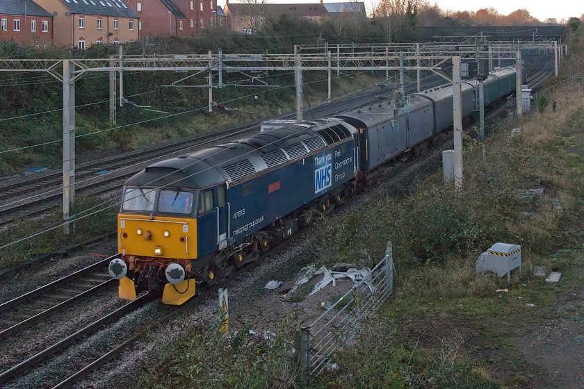 47813, 12.00 Derby RTC-Wolverton Centre Sidings (5H70, 13E), site of Roade station 
 Had this been running much later I would have not managed a photograph! 47813 'Jack Frost' leads a rake of barrier coaches past Roade with 57312 bringing up the rear. As the 5H70 it left Derby RTC heading for Wolverton Works one hundred and ten minutes late and then updates promptly ceased and, for a while, I thought it had been stopped. However, by using Rail Record rather than RTT I was able to ascertain that it had gone off route. Rather than going via the planned route south to Leicester and then across to Nuneaton, it took the Burton route to Litchfield where it took the spur on to the WCML to then change ends and head south on the WCML as per planned from Nuneaton. All these shenanigans should have added even more time but it was suddenly now twenty-two minutes early as it joined the Northampton loop at Hilmorton Junction! It lost a little time being held at Northampton but passed me here at Roade ten minutes ahead of schedule. 
 Keywords: 47813 12.00 Derby RTC-Wolverton Centre Sidings 5H70 site of Roade station Jack Frost