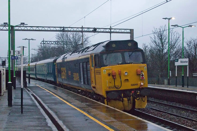 50049, outward leg of The Manchester Christmas Markets, 07.48 London Euston-Preston (1Z50, 1E), Wolverton station 
 50049 'Defiance' dead-in-tow on the rear of the outward leg of The Manchester Christmas Markets charter running appropriately as 1Z50, the 07.48 London Euston to Preston. Seen here, passing Wolverton at speed, the Class 50 was not under power at this point in the journey but later on it was called upon to provide some traction to assist 50007 'Hercules' that was leading the train as it began to lose power. After being some time down due to this issue, this was all caught up on arrival at Preston. 
 Keywords: 50049 The Manchester Christmas Markets 07.48 London Euston-Preston 1Z50 Wolverton station Defiance GBRf