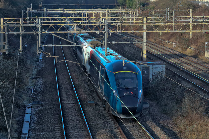 807004, VT 11.43 Liverpool Lime Street-London Euston (1A34, 5L), site of Roade station 
 Just catching a little low sunshine on this very cold Friday afternoon 807004 passes Roade working Avanti's 11.43 Liverpool to Euston service. The use of these new trains on Liverpool diagrams since the start of the winter timetable last month is an interesting move and not one that I think will continue in the long term. 
 Keywords: 807004 11.43 Liverpool Lime Street-London Euston 1A34 site of Roade station Avanti West Coast Evero.jpg