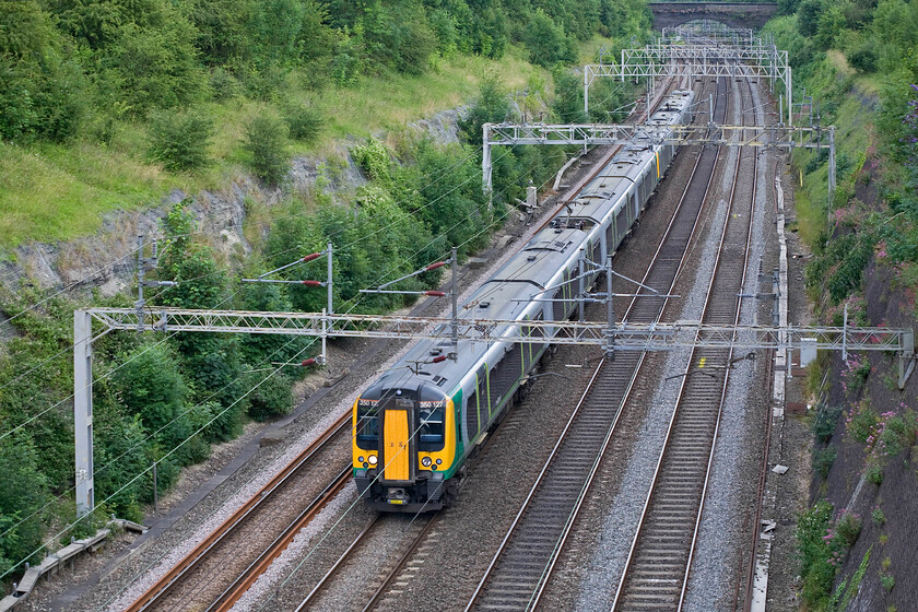 350127 & 350128, LM 17.54 London Euston-Northampton (2N99), Roade Cutting 
 The 17.54 Euston to Northampton Saturday evening service passes through Roade cutting close to the end of its journey. It is being worked by a pair of consecutively numbered London Midland Desrios in the form of 350127 and 350128 
 Keywords: 350127 350128 17.54 London Euston-Northampton 2N99 Roade Cutting London Midland Desiro