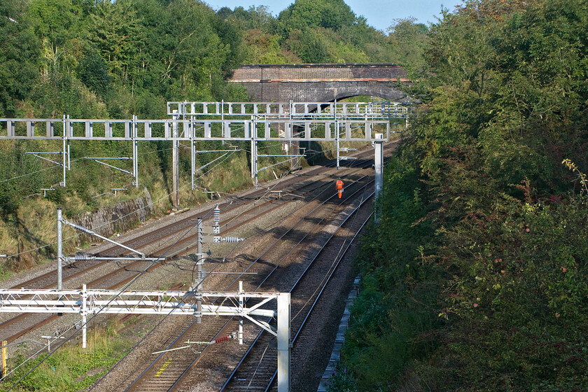 Trackworker, A508 bridge 
 A lone trackworker makes his way along the down slow line at Roade taken from the village's A508 road bridge. He is walking towards the deep cutting just around the curve under Hyde Road bridge. 
 Keywords: Trackworker A508 bridge