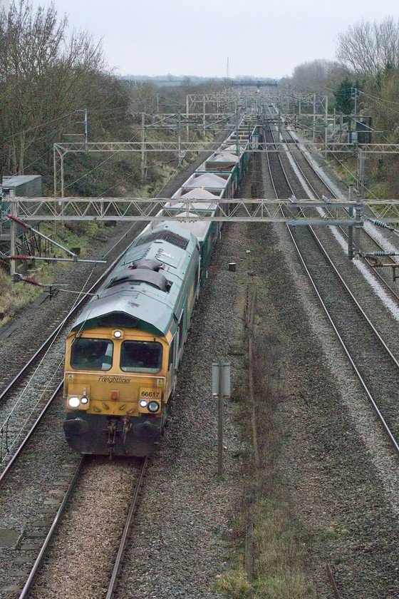 66617, 13.20 Willesden Yard-Tunstead Sidings (6H50, 18L), Victoria bridge 
 With the light now so dire the camera's ISO was ramped up to 12800 and this was the last train of our short birthday related trip out! 66617 works the 13.20 Willesden Yard to Tunstead Sidings past Victoria bridge between Roade and Ashton. Whilst most of the wagons were empty I am not sure as to why there were a number still loaded with ballast going back to where they were quarried? 
 Keywords: 66617 13.20 Willesden Yard-Tunstead Sidings 6H50 Victoria bridge