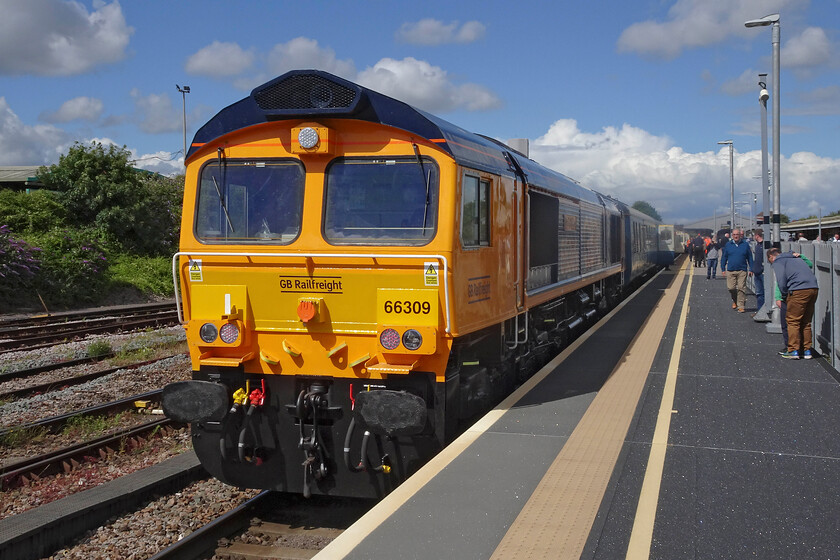 66309, return leg of the Westbury Wizzo, 15.15 Cranmore-East Midlands Parkway (as far as Westbury), (1Z79, 12L), Westbury station 
 66309 'Charley Wallace' is seen at the rear of the returning Westbury Wizzo charter after its arrival back into Westbury. It had been used on the charter when it left Network Rail metals on to the East Somerset railway. It took some time for GBRf staff to detach the 66 from the rear of the train before D1015 'Western Campion' could lead the train back towards the London area. 
 Keywords: 66309 Westbury Wizzo 15.15 Cranmore-East Midlands Parkway 1Z79 Westbury station Charley Wallace