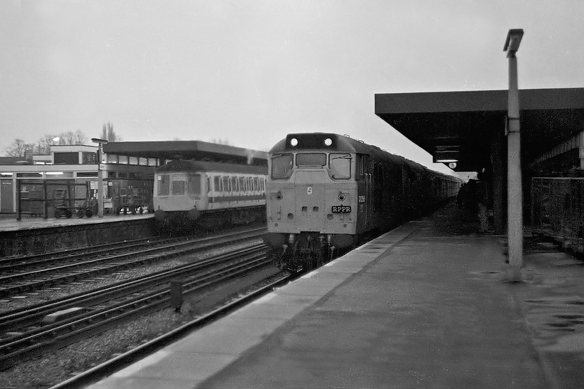 31256 & 31208, outward leg of The Crewe Campaigner Relief, 07.35 London Paddington-Crewe (1Z68) & L402, unidentified up working, Oxford station 
 In the dull half-light at Oxford station, 31256 and 31208 arrive with the The Crewe Campaigner Relief railtour. We took this train from here all the Way to Crewe via Birmingham New Street and Shrewsbury. In the background a class 117 DMU, set L402, waits with an up service, probably to Paddington. Interestingly, the previous summer that actual DMU also wore the modest RPPR headboard as carried by 31256 when it worked The Merry-Go-Round railtour that took in all sorts of rare track in the Thames Valley. 
 Keywords: 31256 31208 The Crewe Campaigner Relief 07.35 London Paddington-Crewe 1Z68 L402 unidentified up working Oxford station