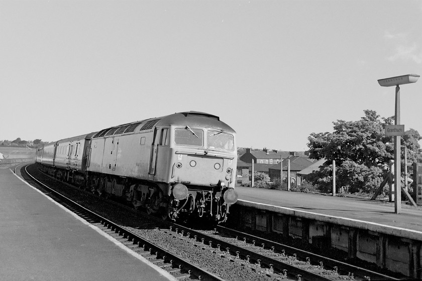 47498, unidentified York-London Kings Cross working, Grantham station 
 47498 leans into the curve at the northern end of Grantham station working an unidentified York to King's Cross service. Simon and I were waiting on the station to catch a train to York, hoping for a Deltic, but were a little disappointed when 47462 came in from King's Cross. 
 Keywords: 47498 York-London Kings Cross working Grantham station