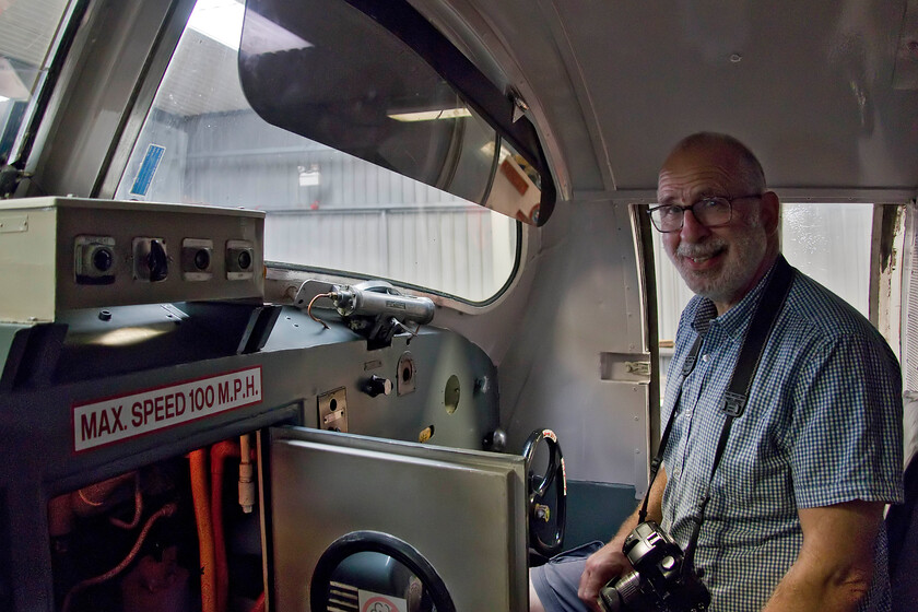 Andy in secondman's seat, 55015, on display, DPS Depot, Barrow Hill 
 Andy enjoys a few moments sitting on the secondman's seat inside the restored cab of 55015 'Tulyar' at the DPS depot at Barrow Hill. Andy grew up with the sounds of Deltics ringing in his ears and cutting his spotting teeth on the class as he lived his early years in Finsbury Park just a short distance from the ECML and the infamous depot of the same name. In the coming months once again 55015 will fire up its engines for the first time in many, many years and will be hauling trains thanks to the incredible and dedicated work of the DPS. 
 Keywords: Andy in secondman's seat 55015 on display DPS Depot, Barrow Hill Tulyar Deltic Preservation Society