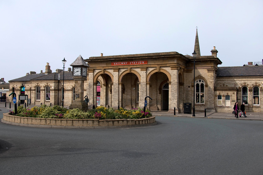 Frontage, former Saltburn station 
 The frontage of the former Saltburn station complete with British Railways tangerine enamel sign. It's an odd sign, simply saying 'railway station' and as such, I thought that it might be a reproduction. However, on studying past images of the station it appears to have been there for many years. The grand station building was built by the Stockton and Darlington Railway finally opening, after some delays, in 1861. No longer in railway use, with the simple one-platform station off to the left, the building is now used for retailing and as a community resource for the fine people of Saltburn. The spire of Saltburn Methodist church stands above the station in the background. 
 Keywords: Frontage former Saltburn station