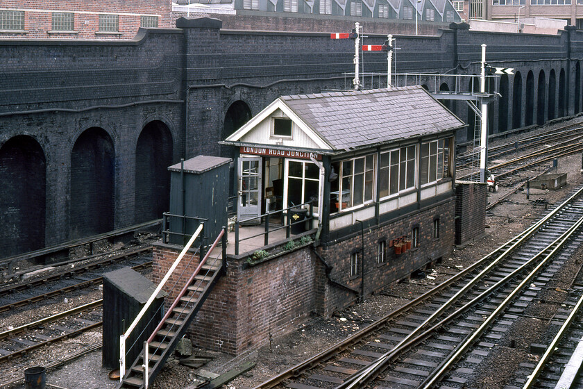 London Road signal box, Leicester (LMS, 1935) 
 With much of the railways immediately on either side of Leicester station lying at a low-level photography in this area always required an element of looking down on to the tracks from the various roads and bridges higher above. Getting an image of Leicester London Road signal box just south of the station required this technique. The LMS Type 11c box opened in December 1935 being fitted out with a fifty-lever Railway Executive Committee frame. It would have been a particularly busy box controlling all movements in and out to the south of the station. It closed on 29.06.86 when signalling between Market Harborough and Syston passed to the new Leicester PSB. Notice the LMS' post-1935 design wooden nameboard and the neat row of three fire buckets attached to some hooks on the front wall of the box. 
 Keywords: London Road signal box Leicester LMS