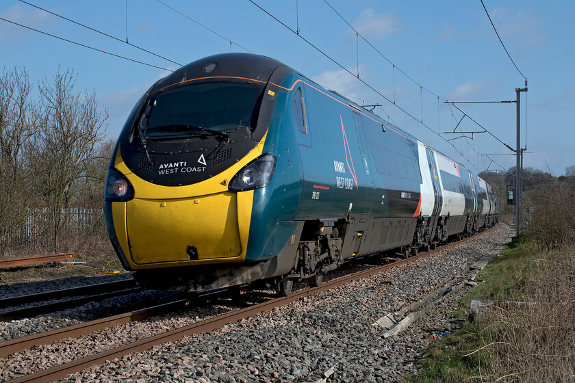 390123, VT 13.10 London Euston-Glasgow Central (1S69, RT), Bugbrooke footbridge 
 390123 is seen at full line speed sixty-six miles north of London working the 13.10 Euston to Glasgow Central service. This spot is near the village of Bugbrooke at a remote former pedestrian crossing deep in the Northamptonshire countryside. On a lovely spring day like this, it was a very pleasant place to spend some time waiting for trains watching the red kites (Milvus milvus) soaring on the thermals and exchanging their haunting calls. 
 Keywords: 390123 13.10 London Euston-Glasgow Central 1S69 Bugbrooke footbridge Avanti West Coast Pendolino